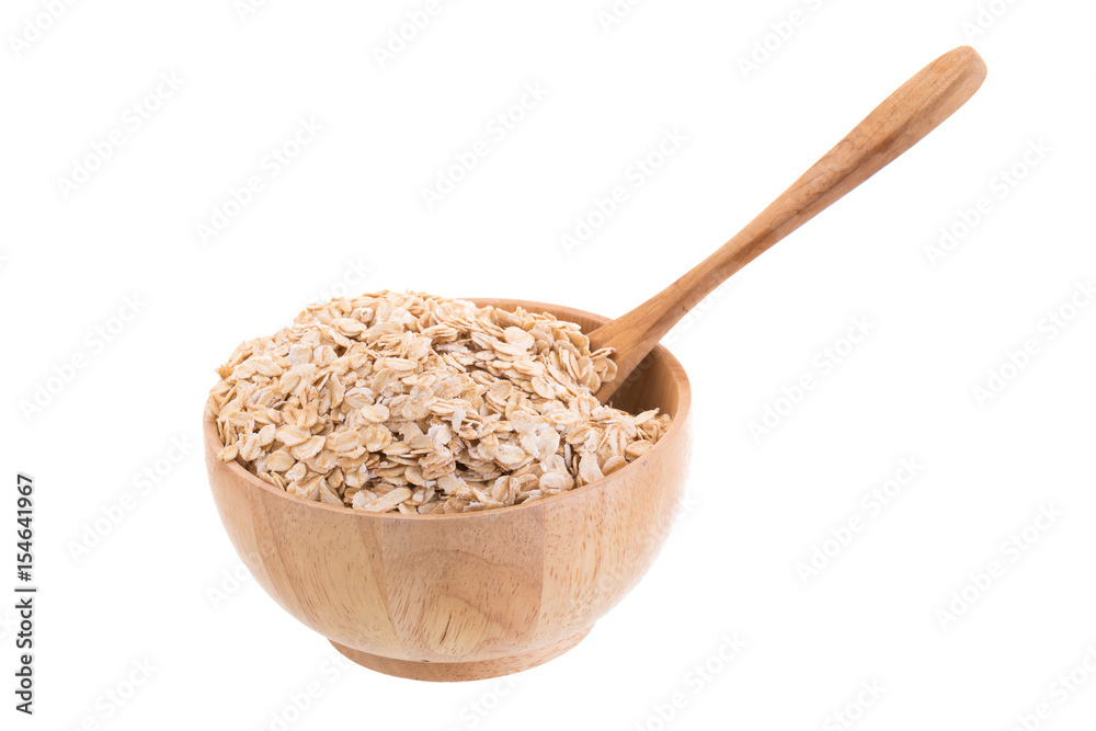 Oat flakes in a wooden bowl on a white background. Oat flakes in a wooden bowl on a white background.