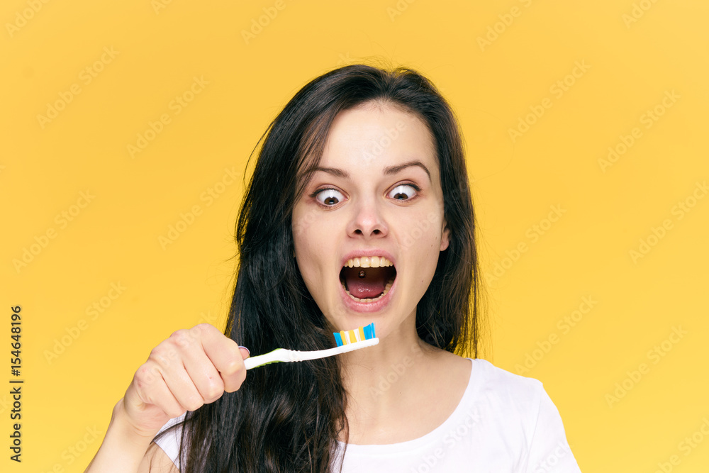 an excited woman with a brush, toothpaste an excited woman with a brush, toothpaste