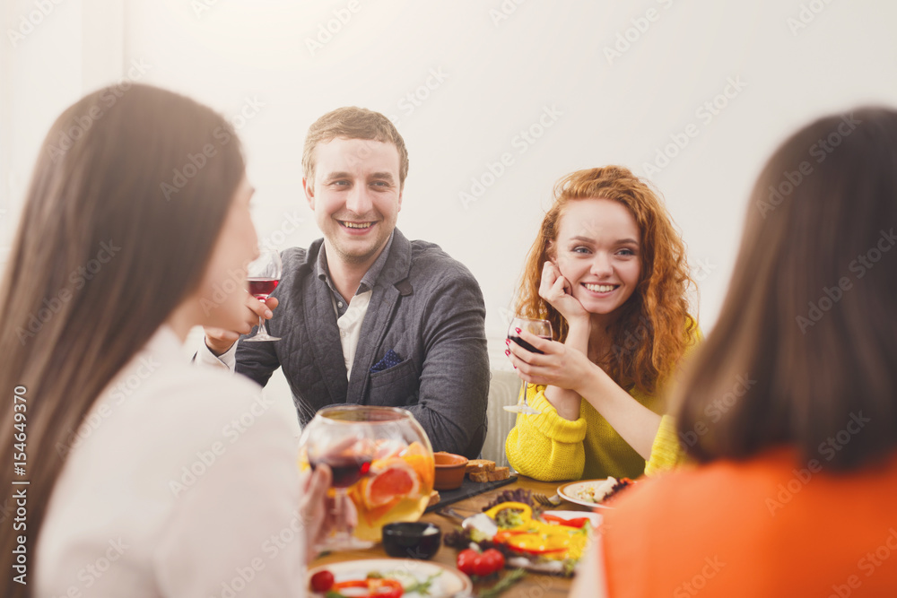 Group of happy young people at dinner table, friends party Group of happy young people at dinner table, friends party