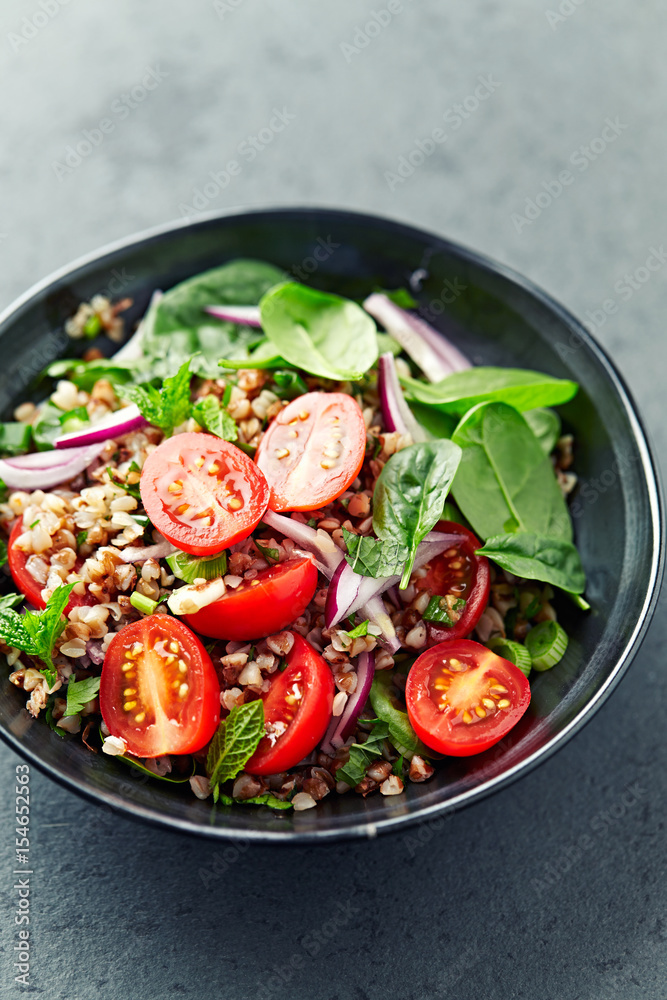 Buckwheat salad with cherry tomatoes and baby spinach