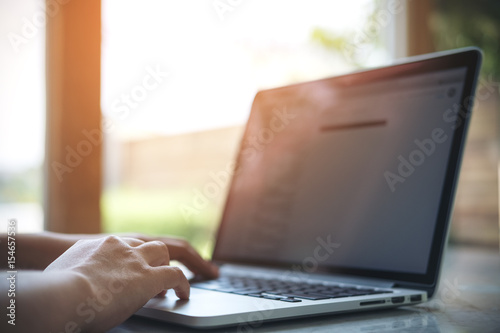 A business woman hands working and typing on laptop keyboard in office