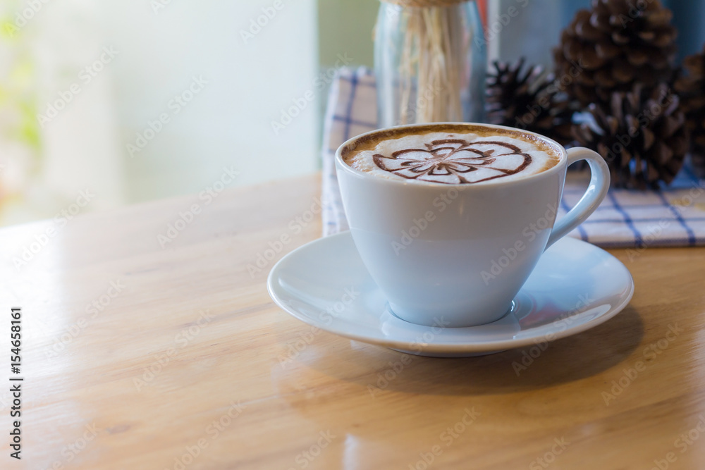 hot coffee with foam milk art in afternoon break. Coffee mocha on the wood desk - obrazy, fototapety, plakaty 