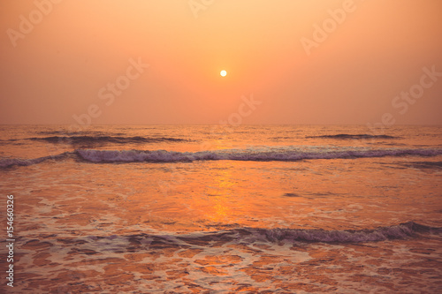 Colorful sunset over the ocean Vagator Beach, south Goa, India.