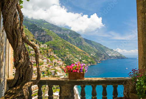 beautiful view of the town of Positano from antique terrace with flowers photo