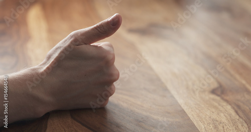 Young man hand finger count at the table