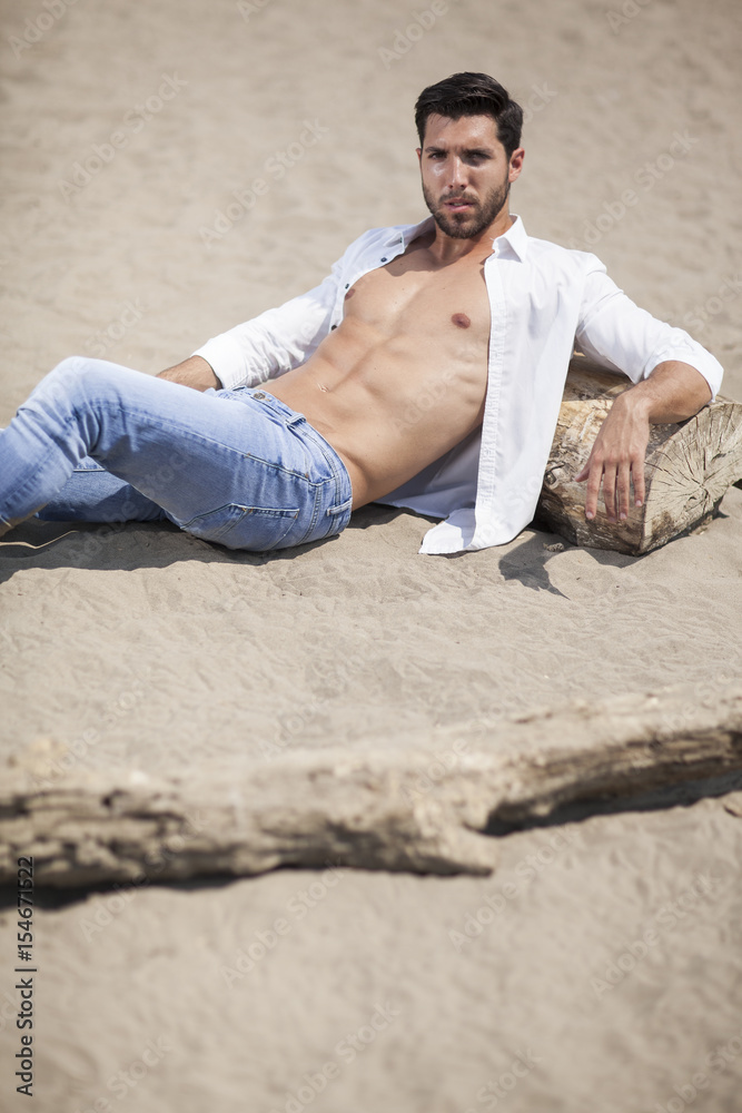 young sexy man on a beach,shallow depth of field