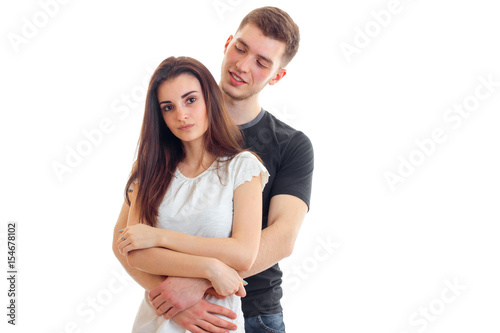 handsome young guy gently hugs sweet girl and smiling