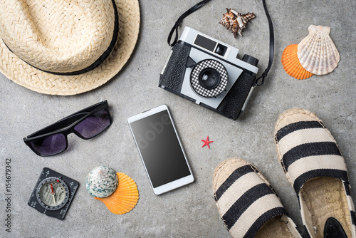 Travel accessories on gray stone background