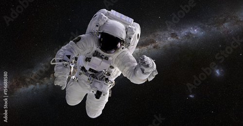 Astronaut in front of the Milky Way galaxy
