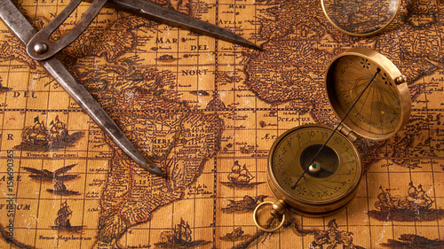 Old vintage retro compass on ancient world map. Vintage still life. Travel geography navigation concept background.