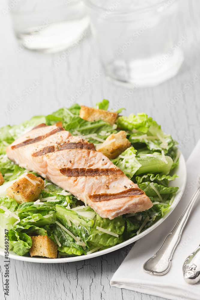 Grilled Salmon Caesar Salad with Glass of Water Grilled Salmon Caesar Salad with Glass of Water