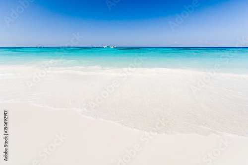 Beautiful tropical beach, white sand and blue sky background with travel yacht boat © BBandSIRI
