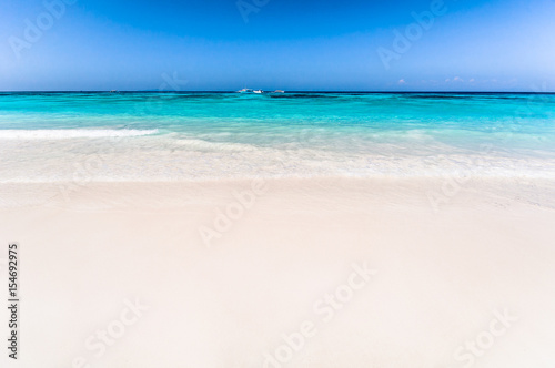 Beautiful tropical beach  white sand and blue sky background with travel yacht boat