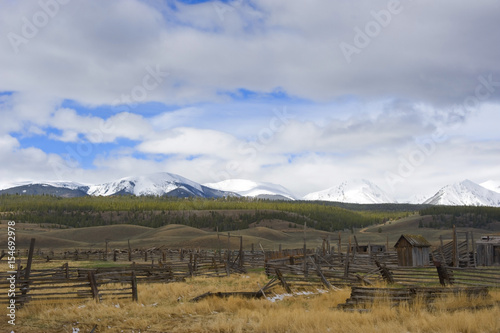 Abandoned Ranch Against Snow Covered Mountain Backdrop