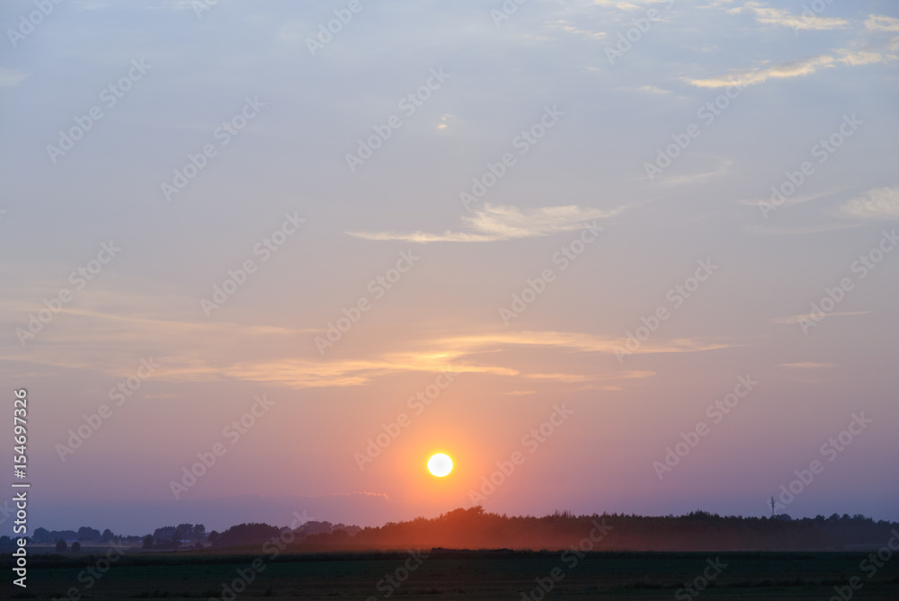 Fototapeta premium sunset over the fields in a horizont