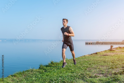 Young jogger running in morning Athlete runner working out cardio. © undrey