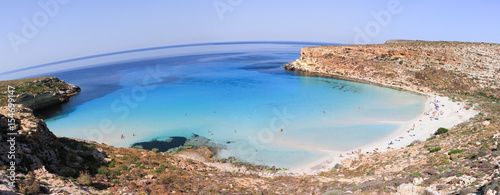 Pure crystalline water surface around an island (Lampedusa) photo