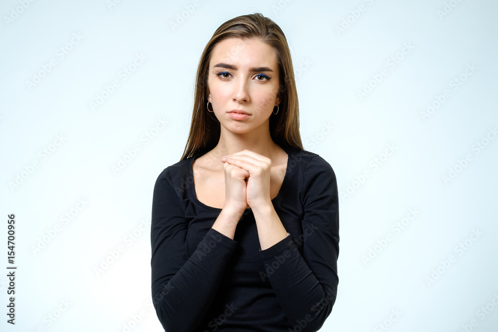 Closeup portrait of a young woman praying isolated Closeup portrait of a young woman praying isolated
