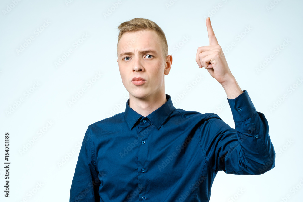 Attractive man showing his forefinger. Good idea or attention gesture Attractive man showing his forefinger. Good idea or attention gesture