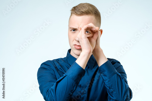 Young man looking far away isolated on white