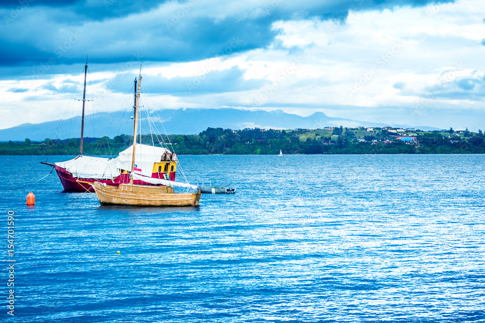 Fototapeta premium Blue ocean with boats and coastline