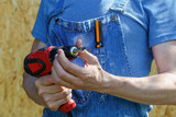 electric screwdriver in the hands of men working