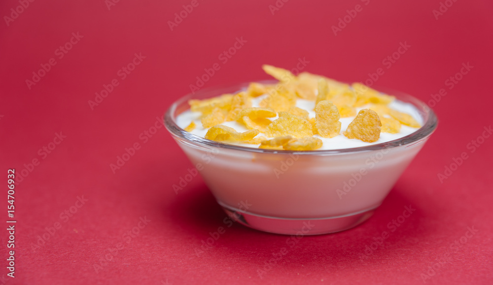 Cereals in milk. Cereals in yogurt. Cereals in bowl on red background. Cereals in milk. Cereals in yogurt. Cereals in bowl on red background.