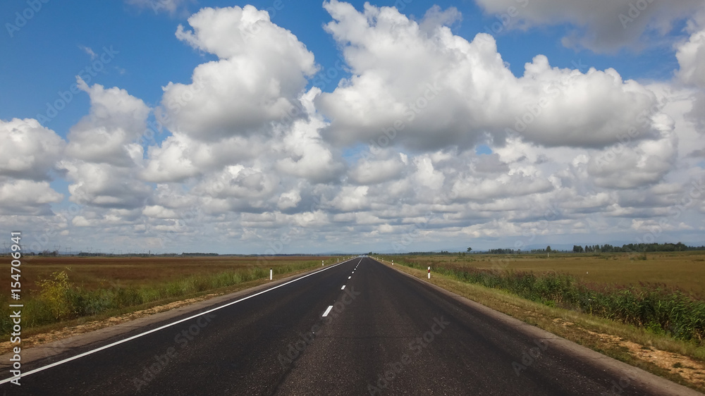landscape of asphalt road in wild field with mountains at horizon landscape of asphalt road in wild field with mountains at horizon