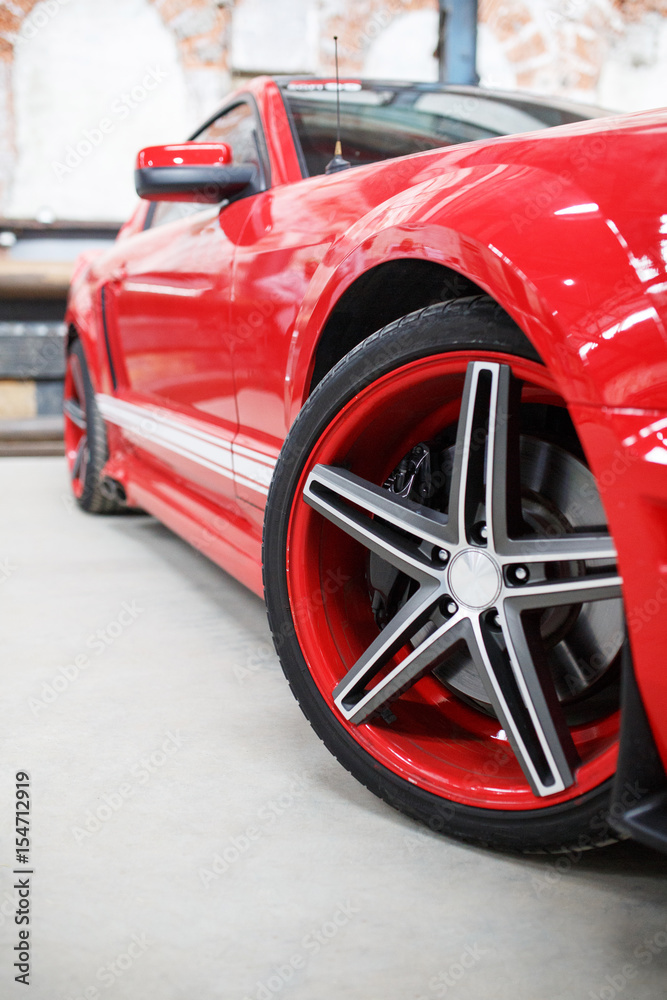 Red car with alloy wheel indoor