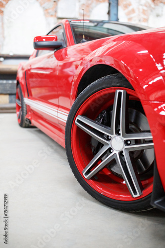 Red car with alloy wheel indoor