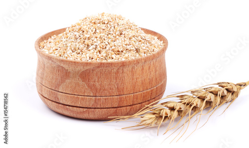 wheat porridge in wooden bowl isolated on white background