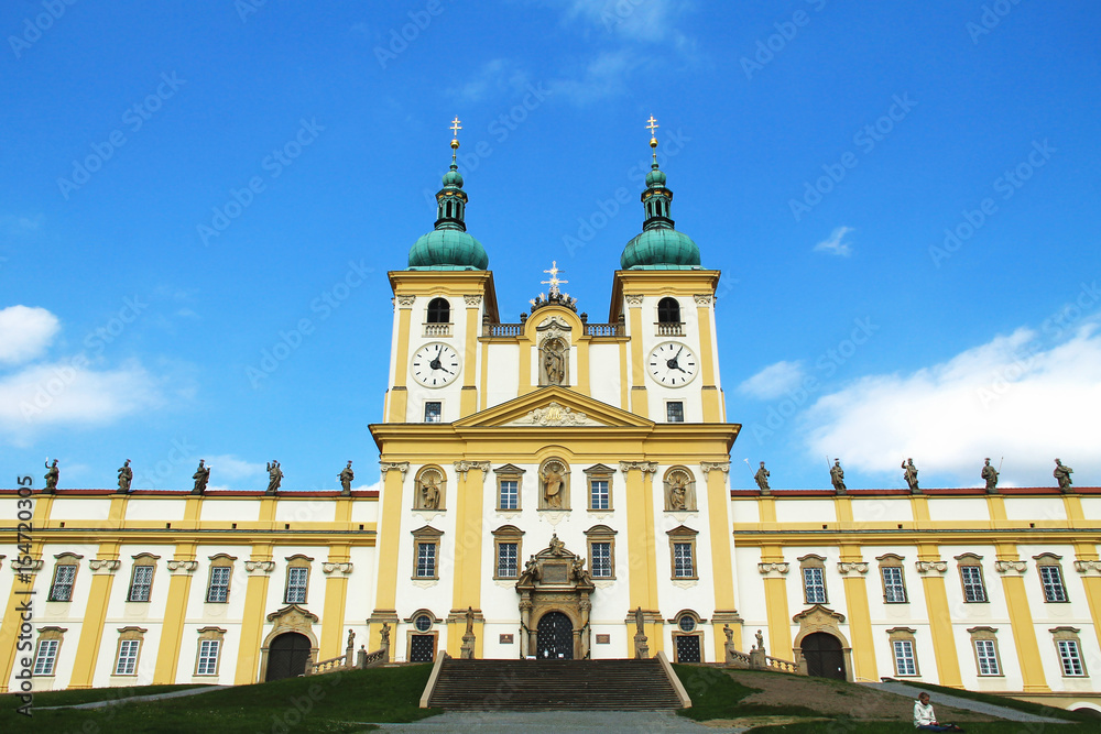 beautiful white and yellow basilica in Olomouc looming up to the sky, Czech Republic