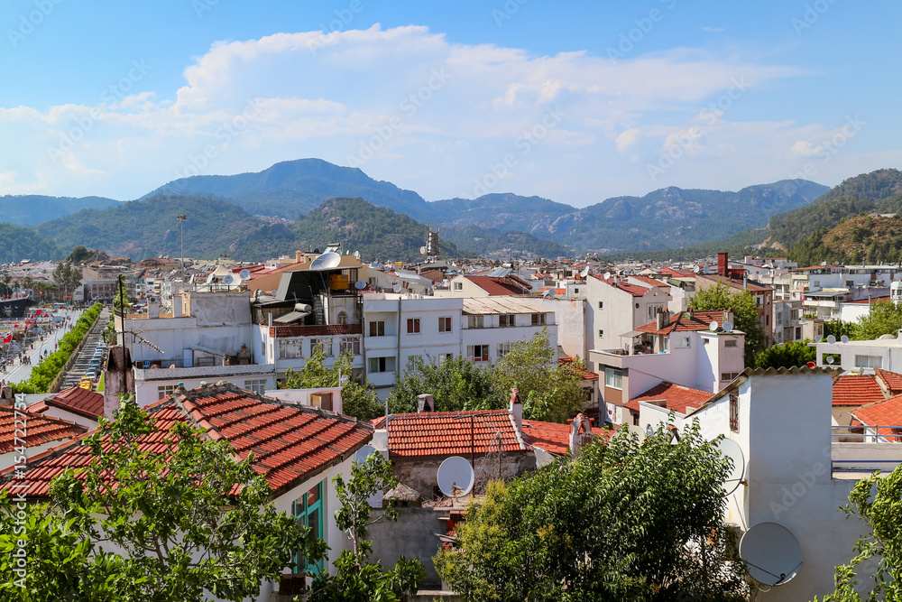 Red roofs and white houses on the sky and mountains of the southern town