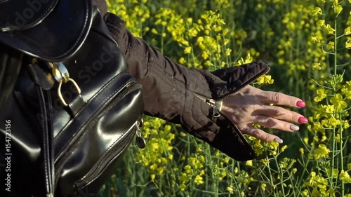 A girl takes a rape-flower hand. Slow motion