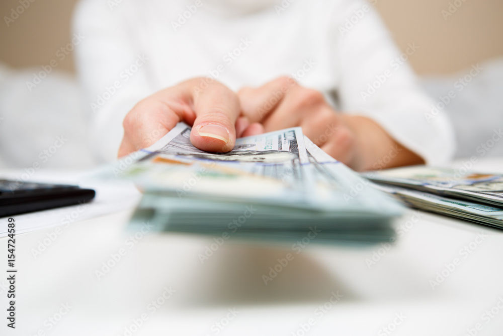 Fototapeta premium Hands of person proposing money to you - closeup shot