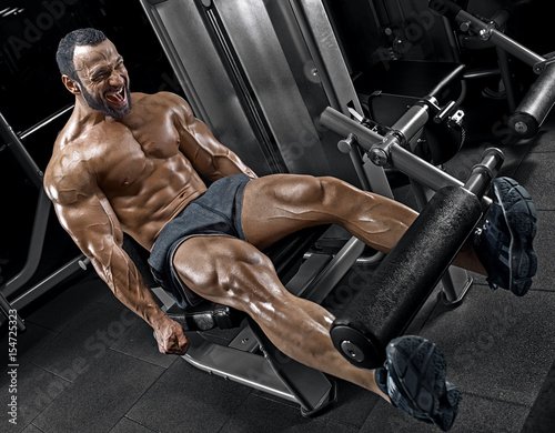 Adult guy bodybuilder posing in gym