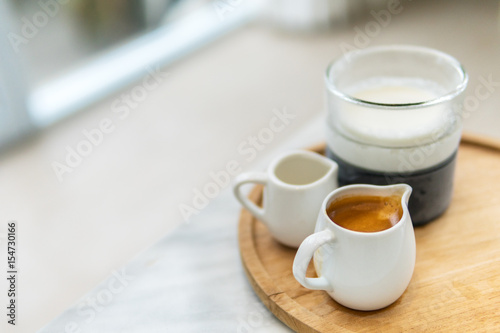 ice coffee latte coffee and milk glasses with syrup on wooden plate coffee on cafe concept refreshment drink in summer vintage tone and selective focus