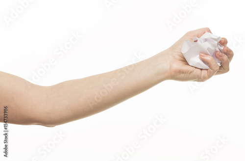 Hand holds a crumpled sheet of paper