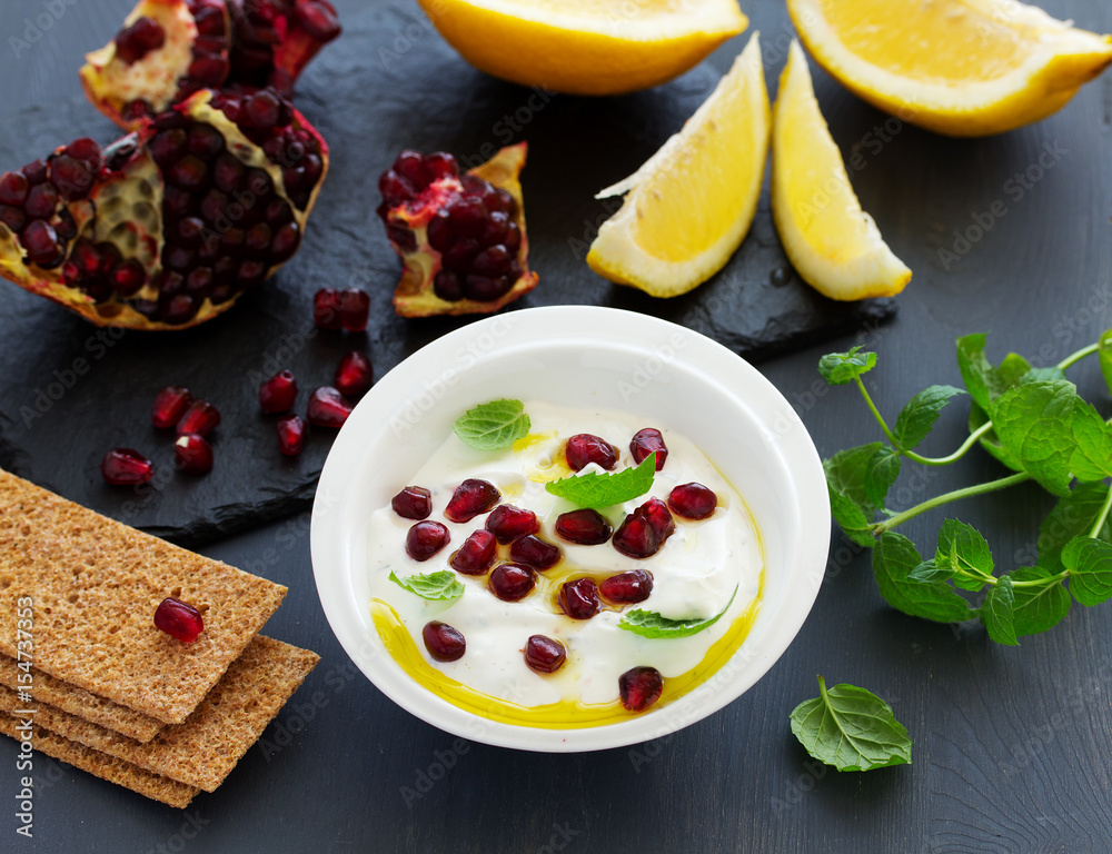The sauce (dip) of yogurt with pomegranate and mint The sauce (dip) of yogurt with pomegranate and mint