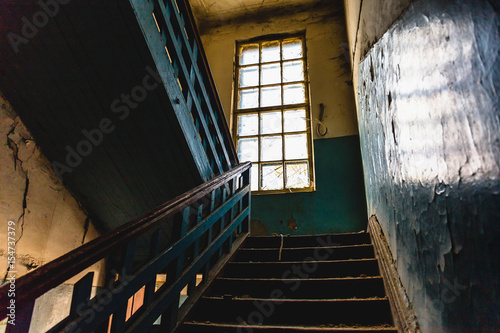 Old vintage staircase interior in dark dirty abandoned building