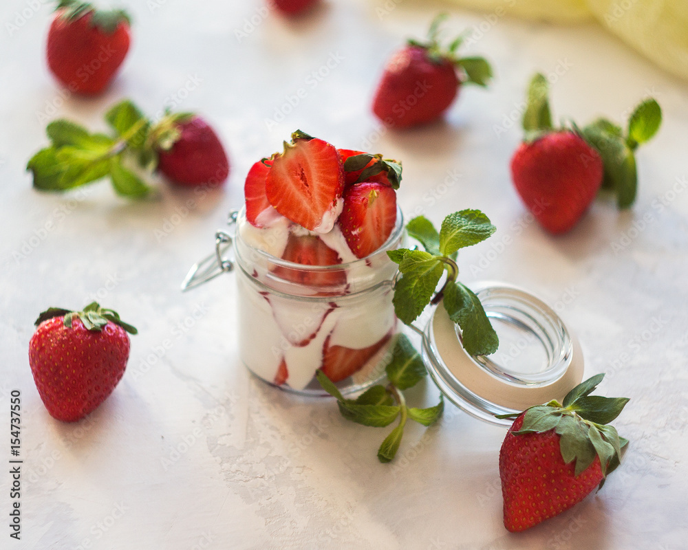 Homemade yogurt with fresh strawberries on a white background Homemade yogurt with fresh strawberries on a white background