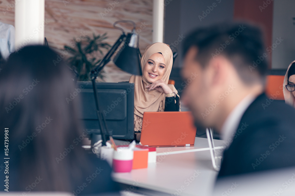 Arabic business woman wearing hijab,working in startup office. Arabic business woman wearing hijab,working in startup office.