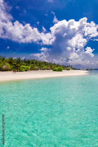 Fototapeta Naklejka Na Ścianę i Meble -  Palm tree on tropical island with turquoise clear water and overwater bungalow, Maldives