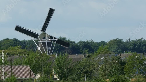 Dutch windmill in small city photo