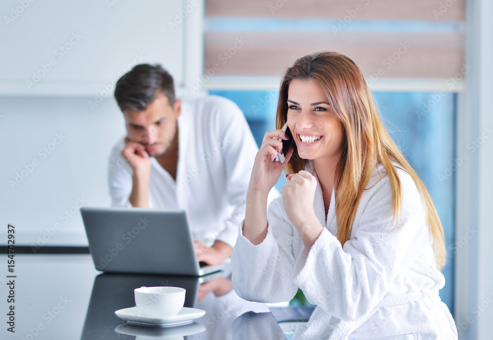 woman wearing a white bathrobe with laptop woman wearing a white bathrobe with laptop