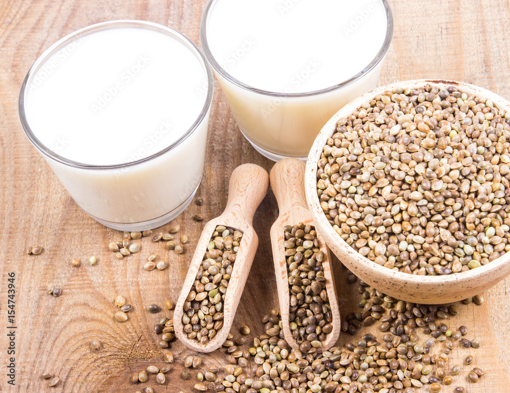 Hemp milk, seeds on wooden background . Close Up . Hemp milk, seeds on wooden background . Close Up .