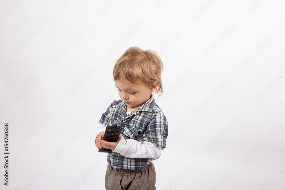 Adorable small boy with a tv remote control Adorable small boy with a tv remote control