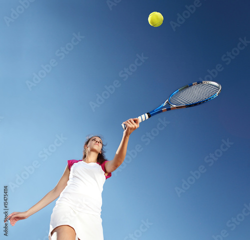 woman tennis player with racket during a match game, isolated © amedeoemaja