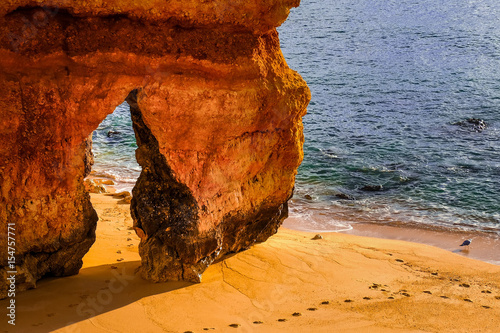 beautiful Atlantic ocean view horizon with sandy beach, rocks and waves. Algarve, Portugal