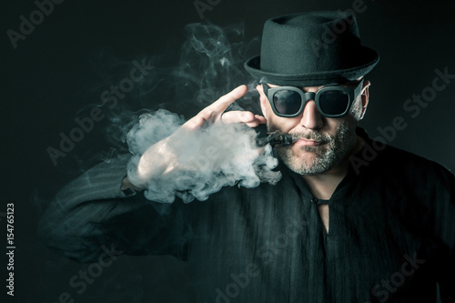 Smoking e-cigarette.